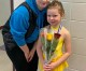 Elliot (right) all smiles with her hard-earned medal and flowers